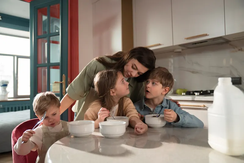 A mother and her three children at the kitchen table